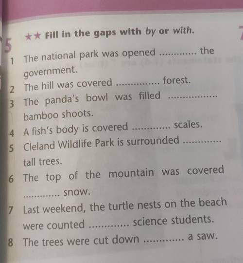 **Fill in the gaps with by or with. 51The national park was openedthegovernment2 The hill was covere